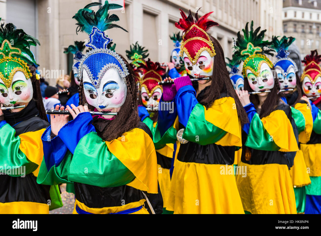 Masked men and women are joining the great procession of Basler Fasnacht, one of the most spectacular events Stock Photo