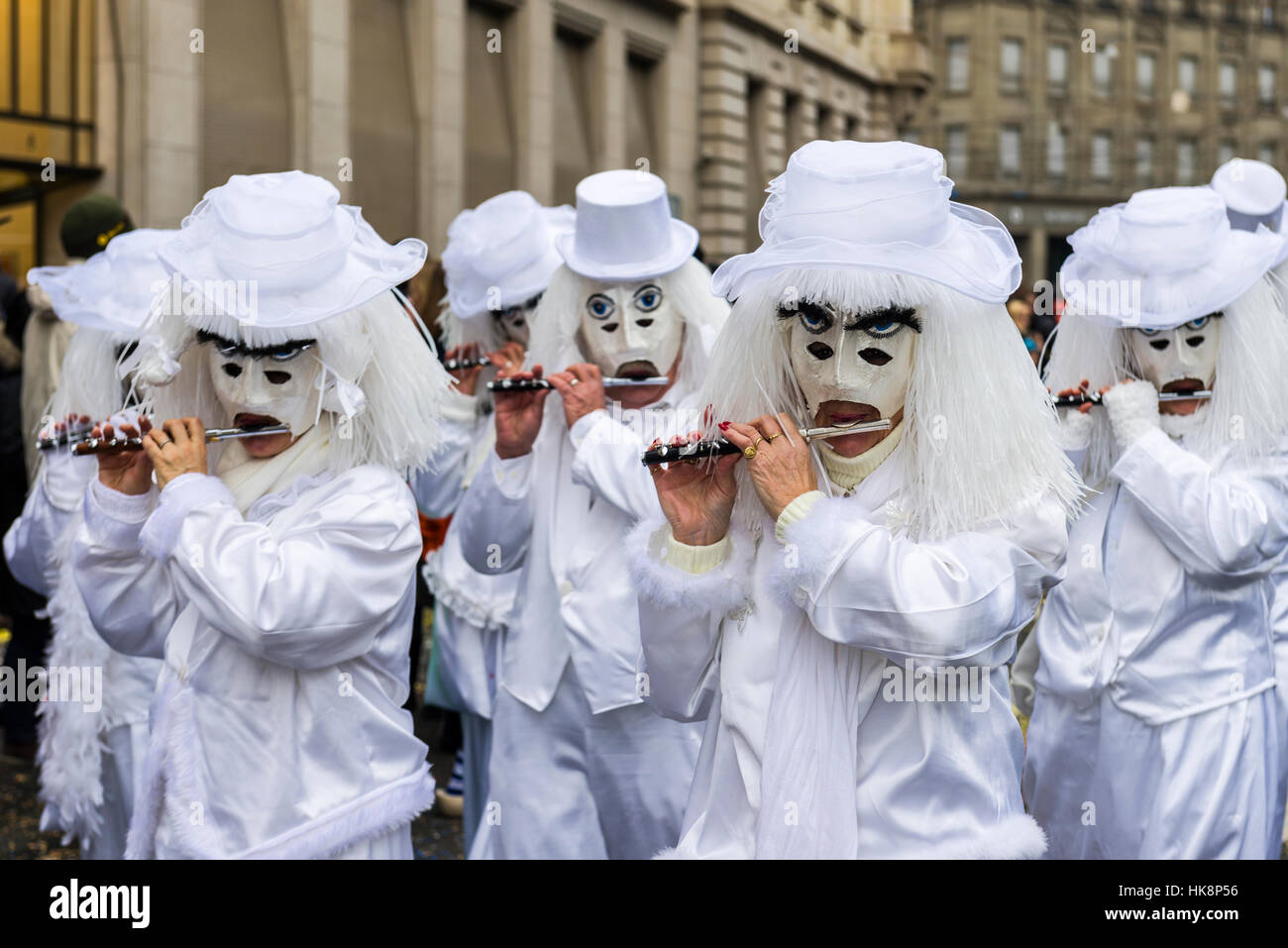 Masked men and women are joining the great procession of Basler Fasnacht, one of the most spectacular events Stock Photo