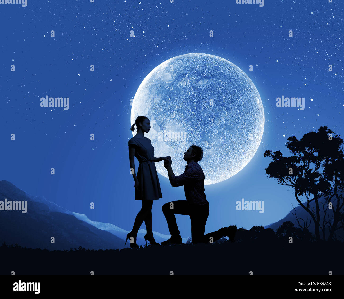 Silhouettes of romantic couple under the moon light Stock Photo - Alamy