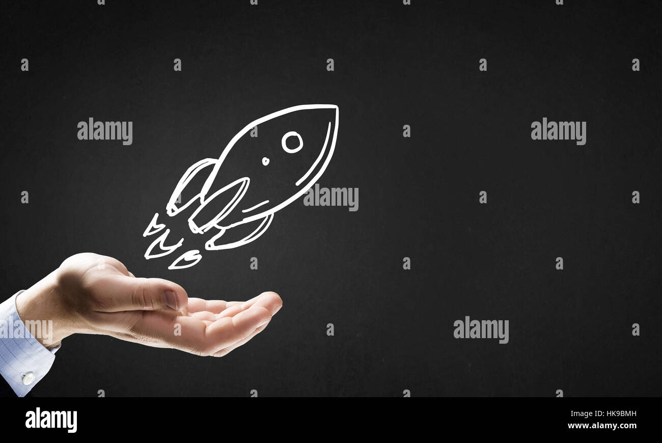 Huma hand showing in palm drawn rocket sign hi-res stock photography ...