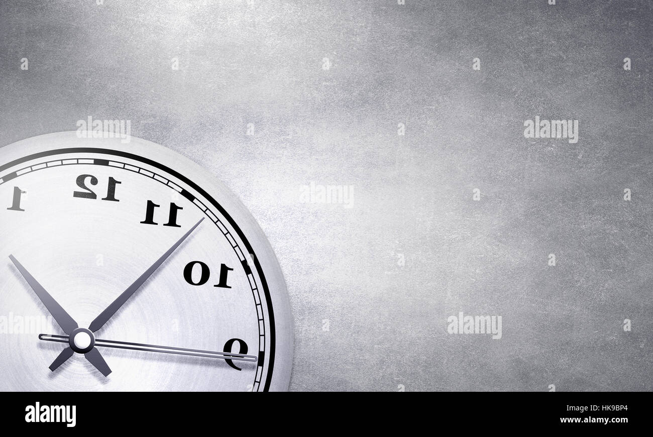 Round wall clock hanging on grey concrete wall Stock Photo - Alamy