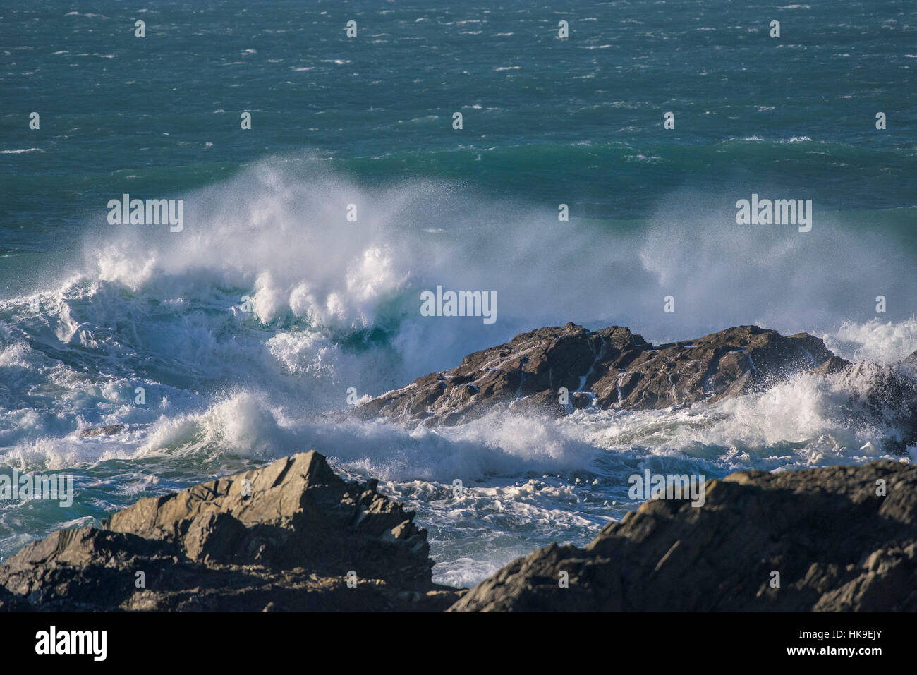 High winds Weather UK spray waves sea Rocks Fistral Newquay Cornwall Stock Photo