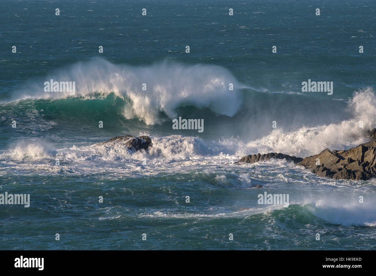 High winds Weather UK spray waves sea Rocks Fistral Newquay Cornwall Stock Photo