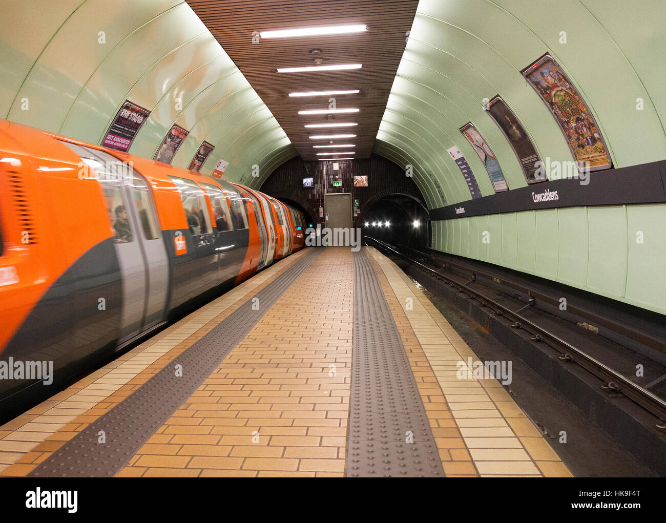 Underground train leaving Cowcaddens Subway Station Glasgow. Stock Photo