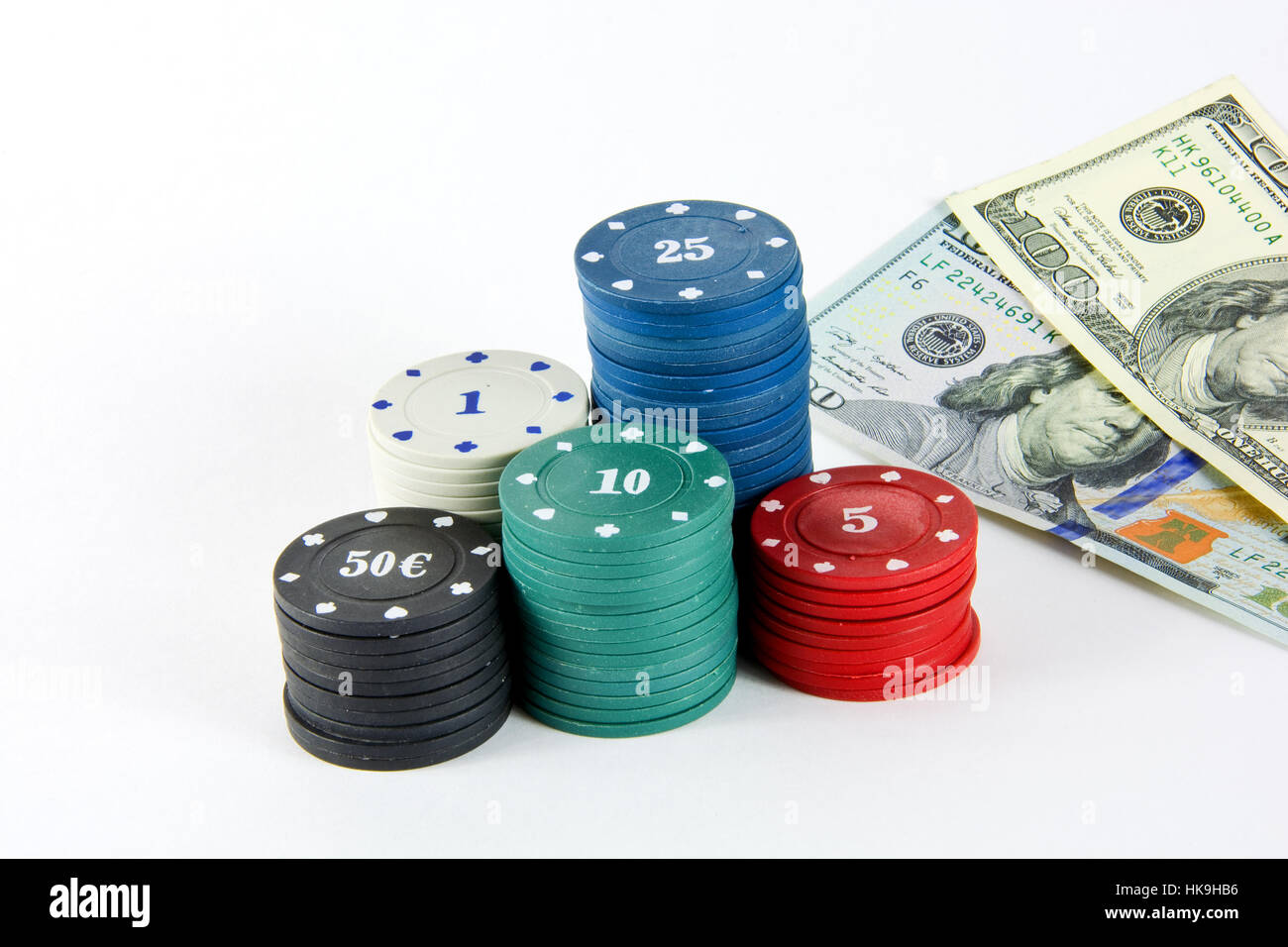 The chips of different values for casino games and 100 banknotes