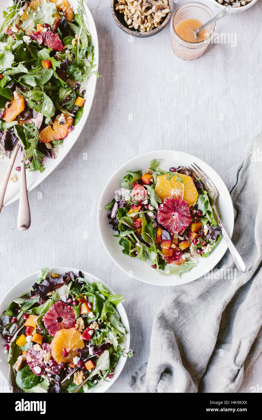 Bowls of Citrusy Roasted Beet Goat Cheese Salad with Black Eyed Peas are photographed from the top Stock Photo
