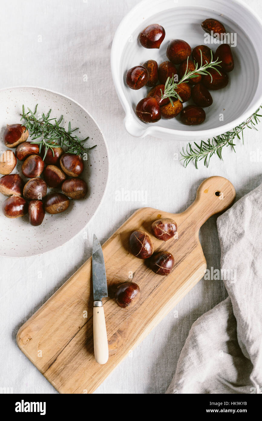 Chestnuts are cut and placed in water before getting ready to be roasted. Stock Photo