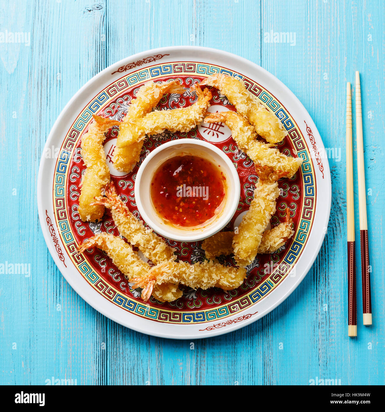 Deep fried breaded Tempura prawn shrimps with sauce on blue background Stock Photo