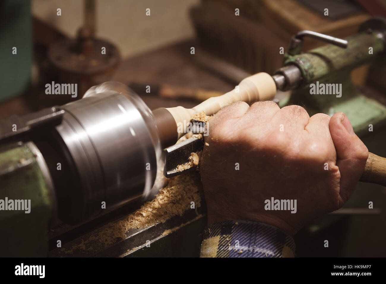 man's hands hold chisel near lathe Stock Photo Alamy