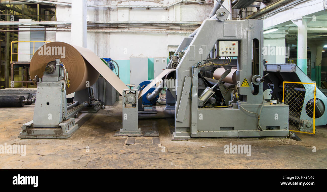 Roll of paper and papermakin machine. Paper manufacturing Stock Photo