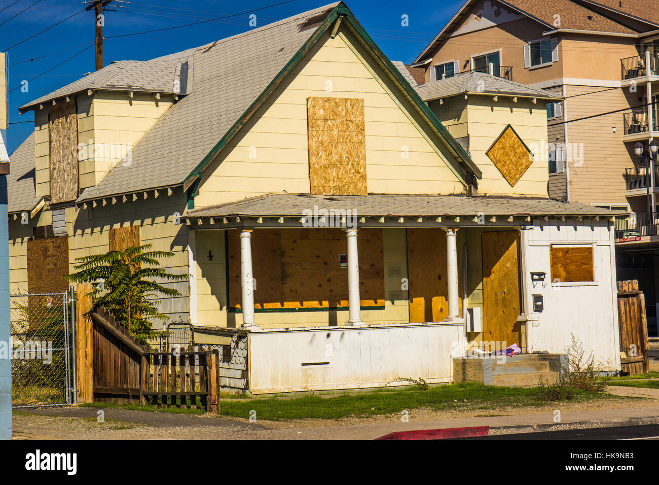 Old Abandoned Home With Boarded Up Windows & Doors Stock Photo