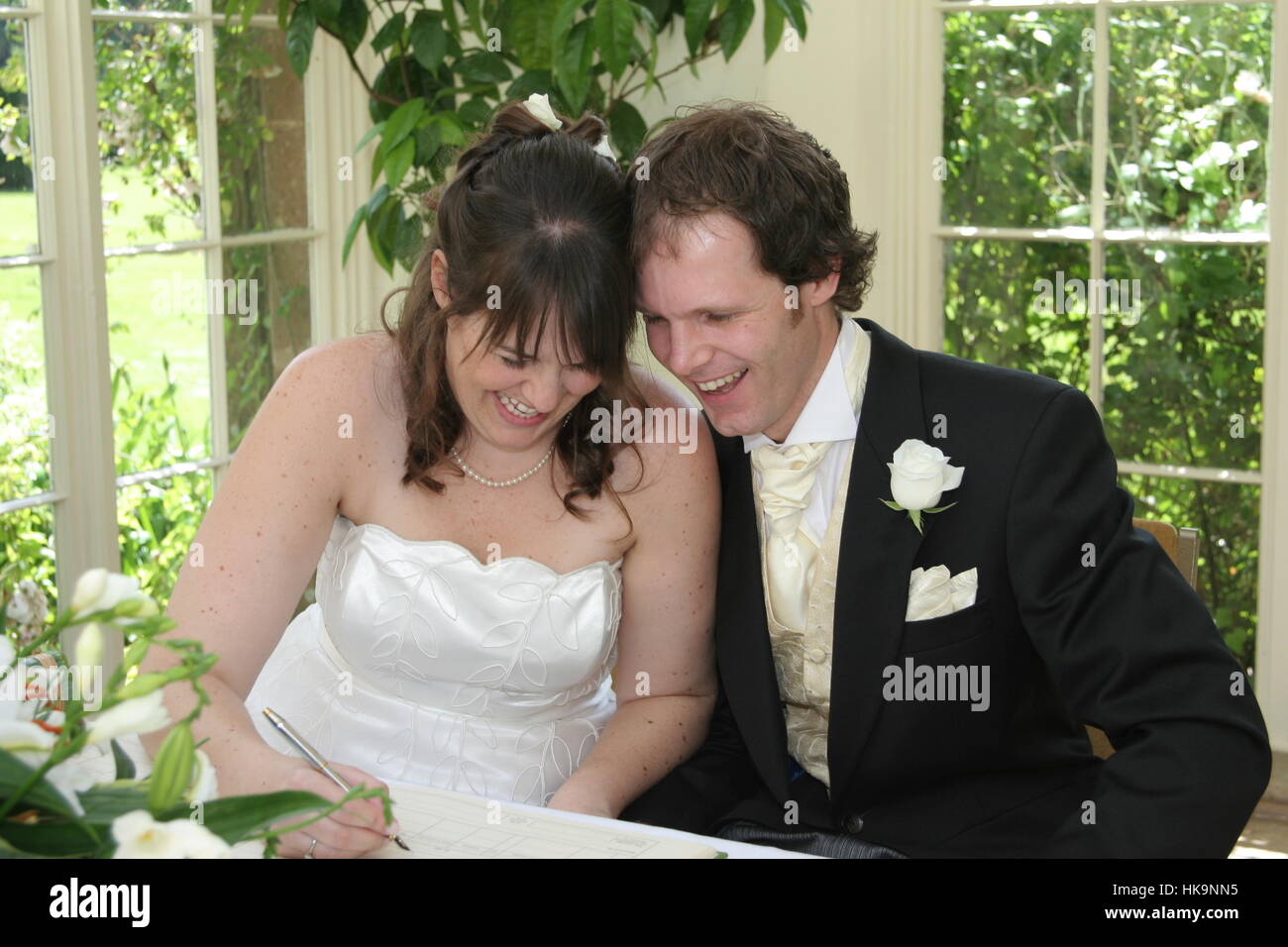 Bride and Groom signing the Register in the Orangery Stock Photo