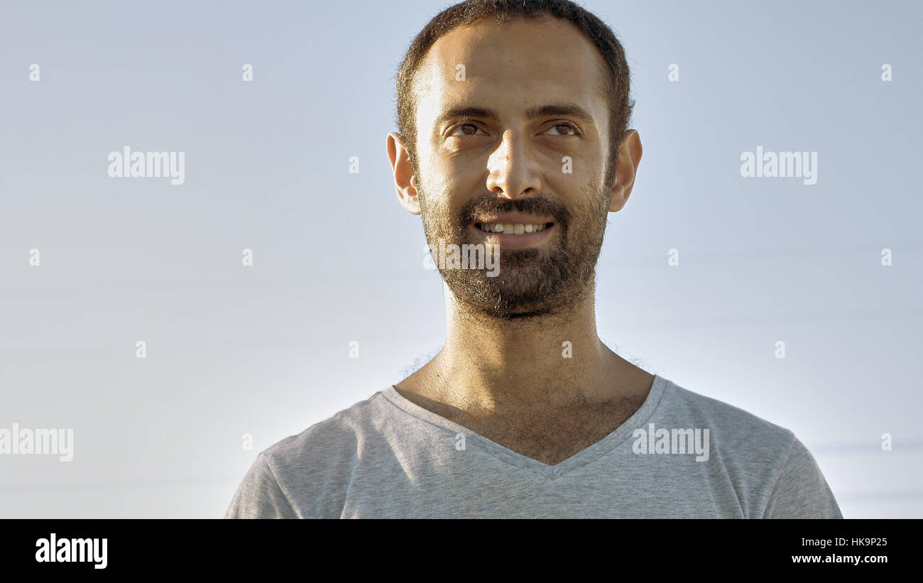 Cheerful man smiles with teeth and nods head Stock Photo