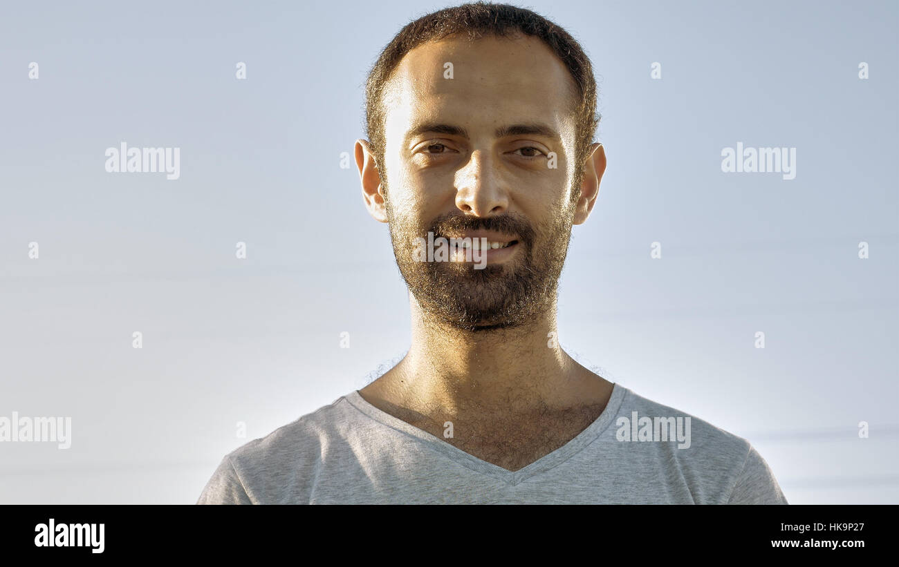 Cheerful man smiles with teeth and nods head Stock Photo