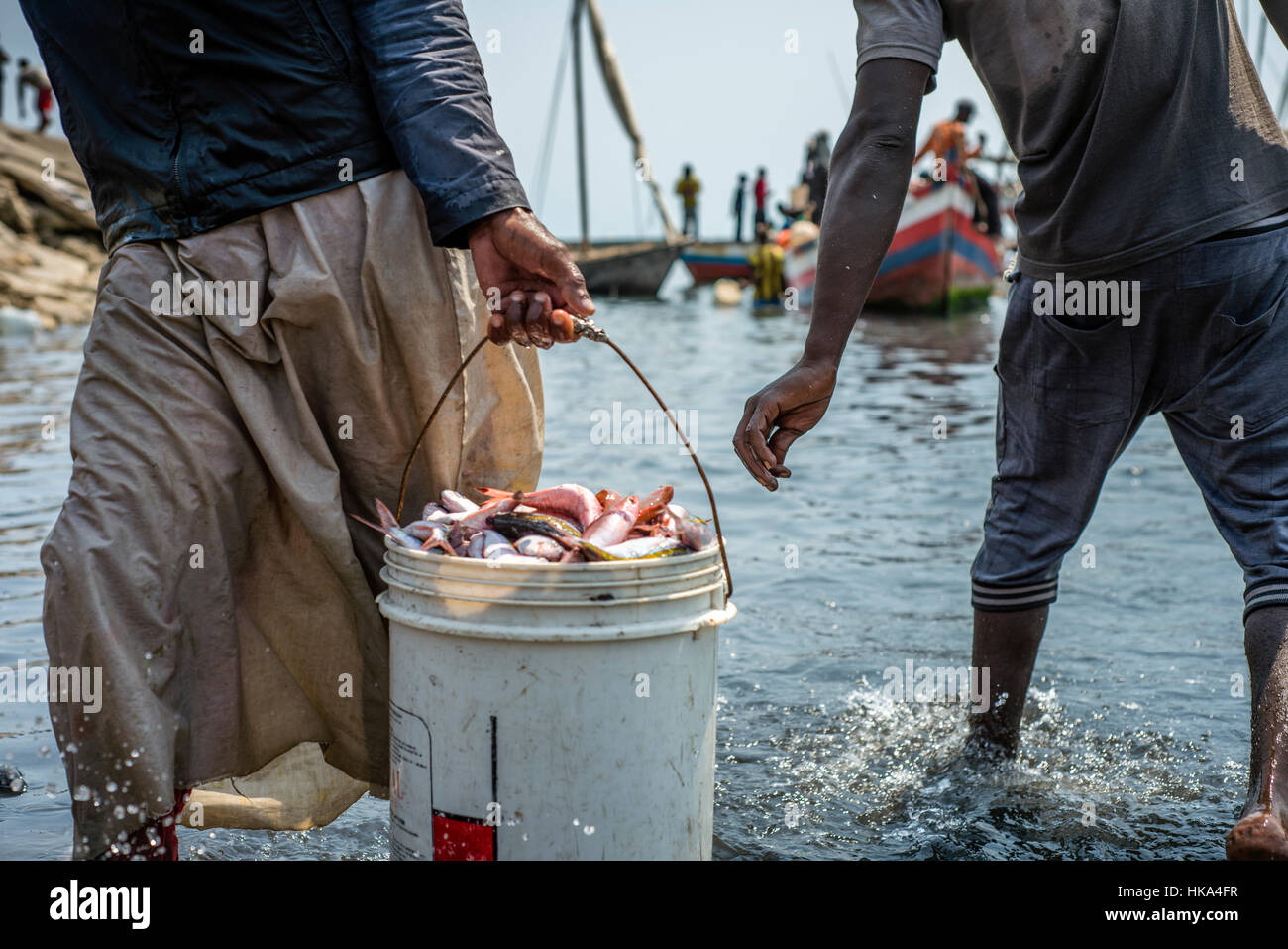 People bargain for better price to buy fish in a local fish market at