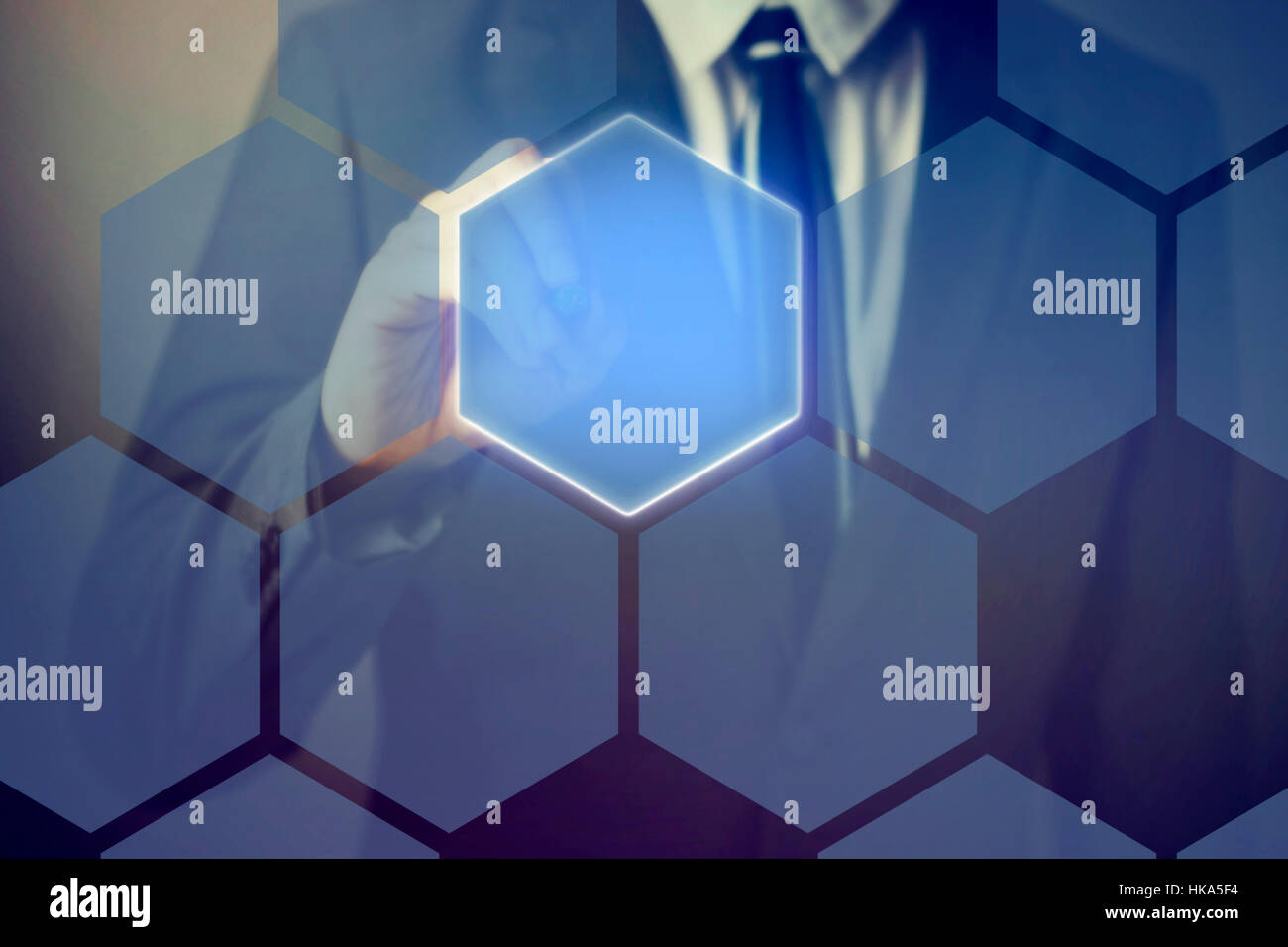 Businessman using pen stylus touching on technology honeycomb interface on virtual screen. Stock Photo
