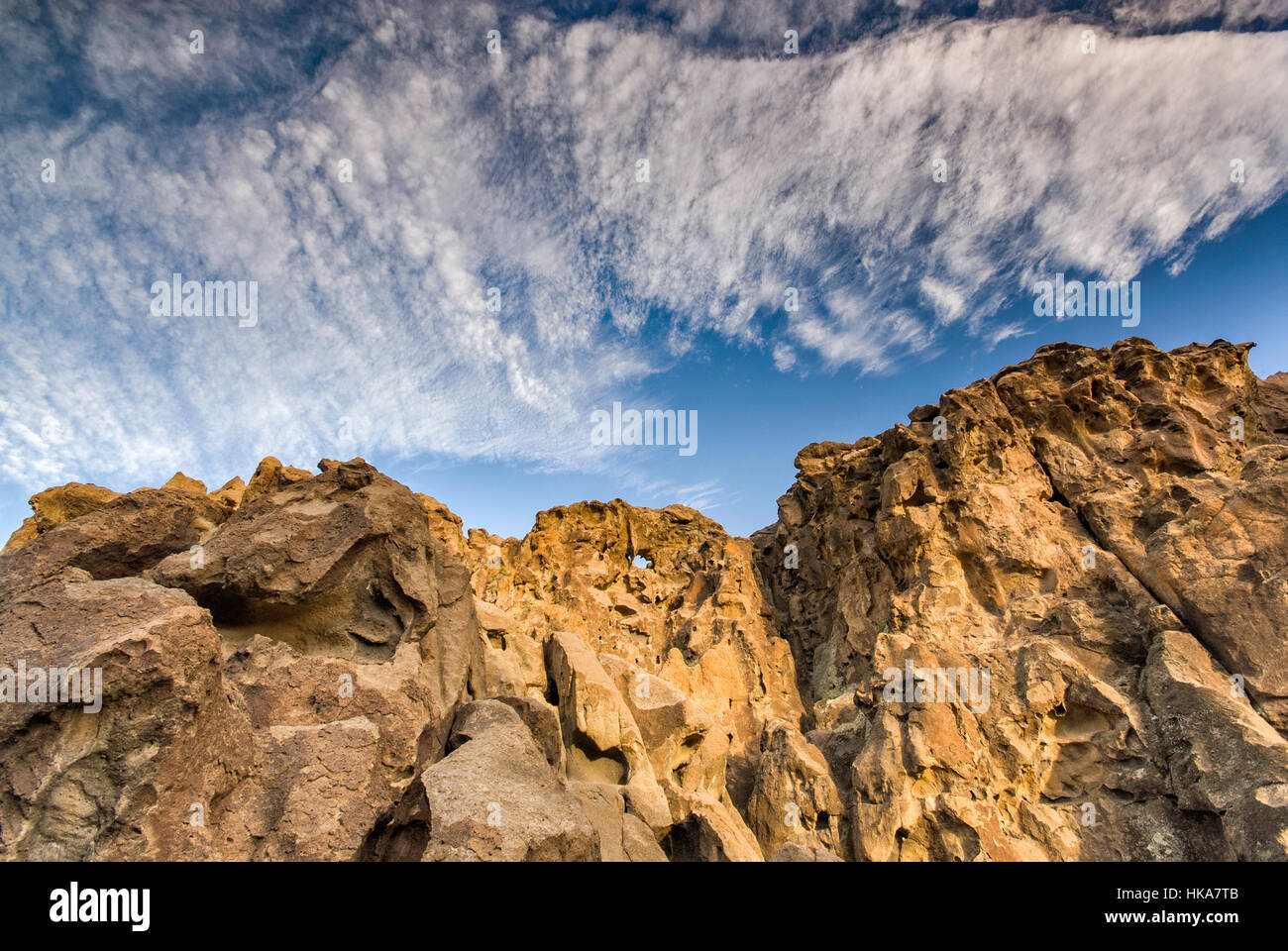 Cirrocumulus and cirrus clouds over Hole-in-the-Wall rocks at Mojave National Preserve, California, USA Stock Photo