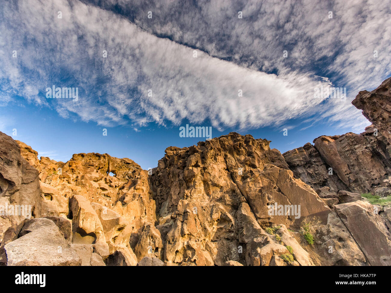 Cirrocumulus and cirrus clouds over Hole-in-the-Wall rocks at Mojave National Preserve, California, USA Stock Photo