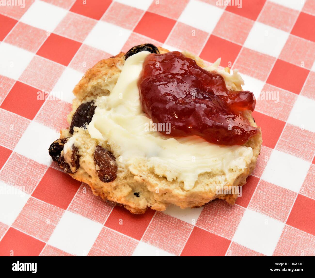 A fruit scone with Strawberry jam and butter Stock Photo Alamy