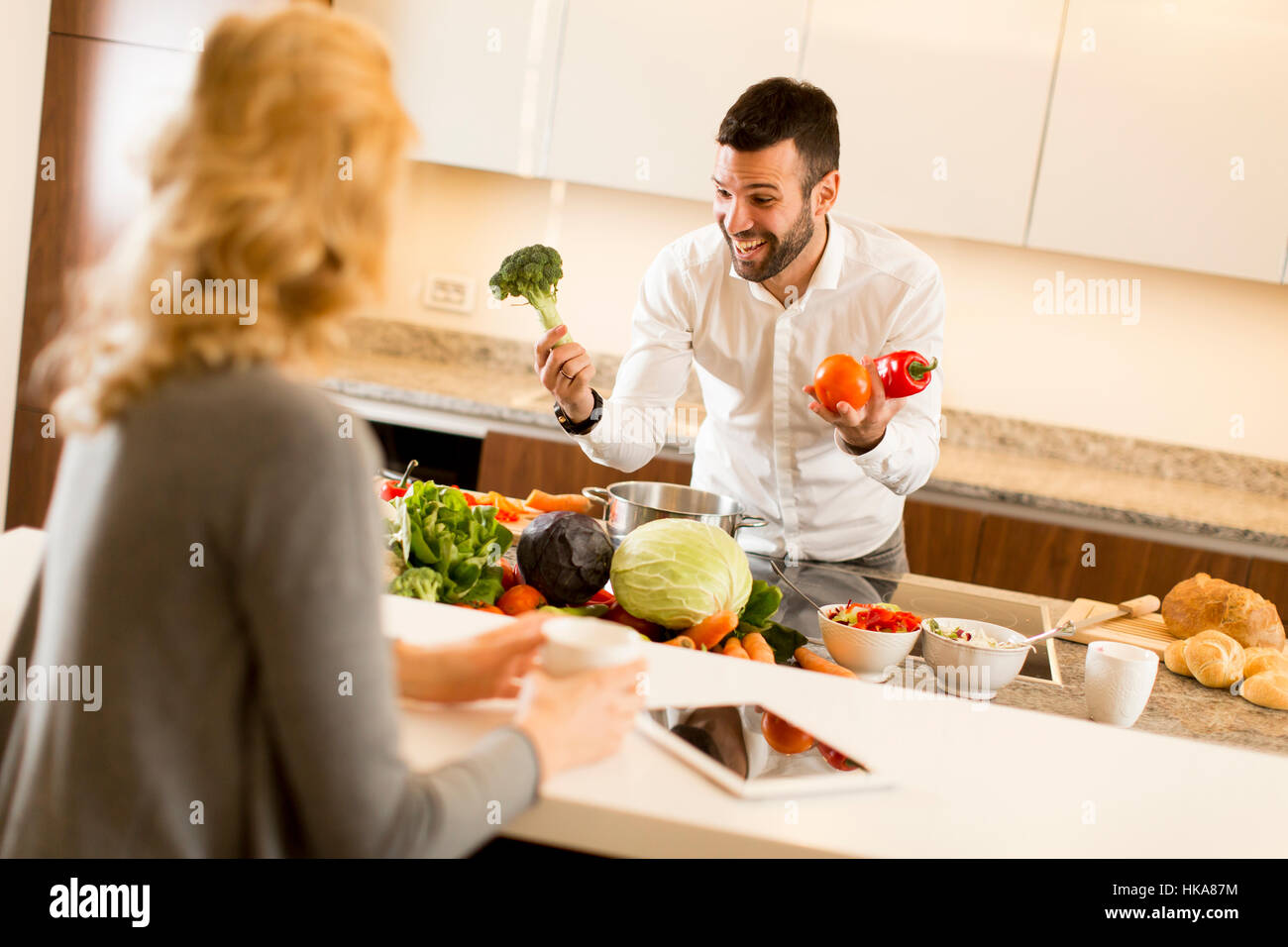 Young couple preparing meal in the modern kitchen Stock Photo