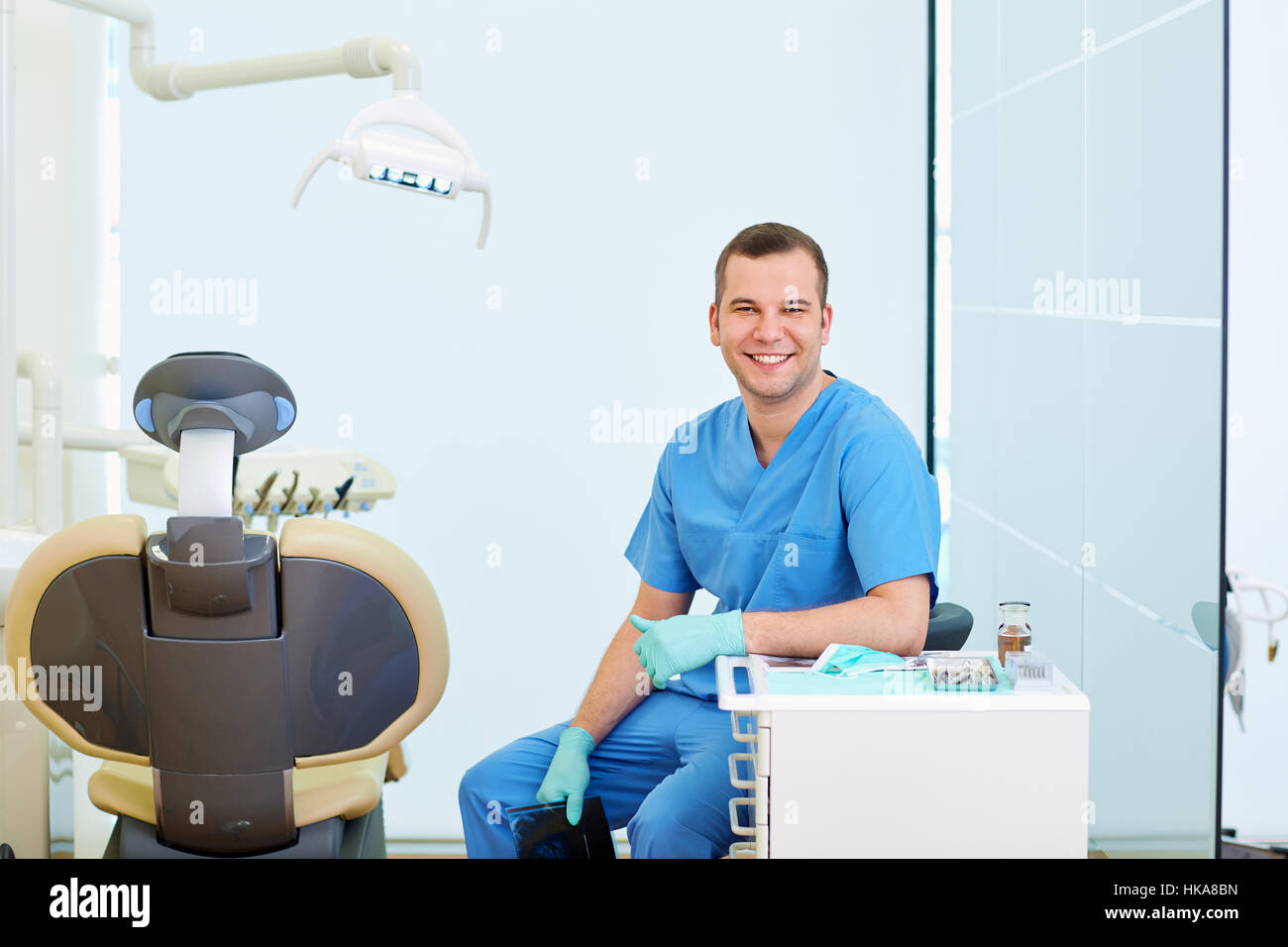 Dentist smiling man sitting in the office Stock Photo - Alamy