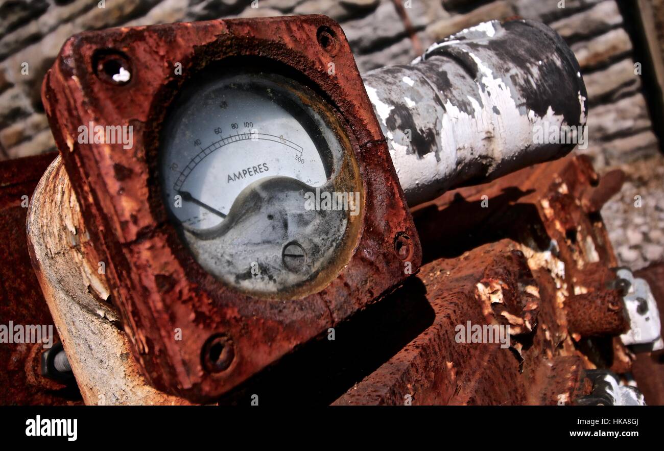 Rusty Industrial Ampere Meter Scrapped in a Disused Mine Yard In Wales Stock Photo