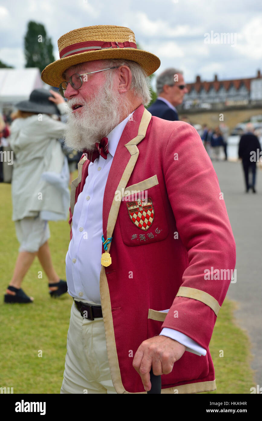 Man wearing red rowing blazer standing chatting on the riverbank at Henley Royal Regatta, Henley-on-Thames, England, UK Stock Photo