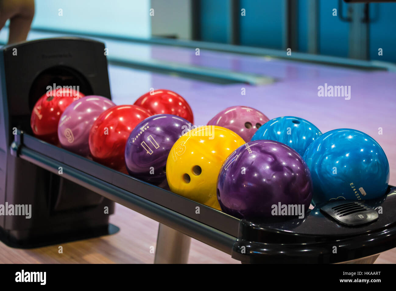 Bowling balls and wooden lane in bowling hall Stock Photo