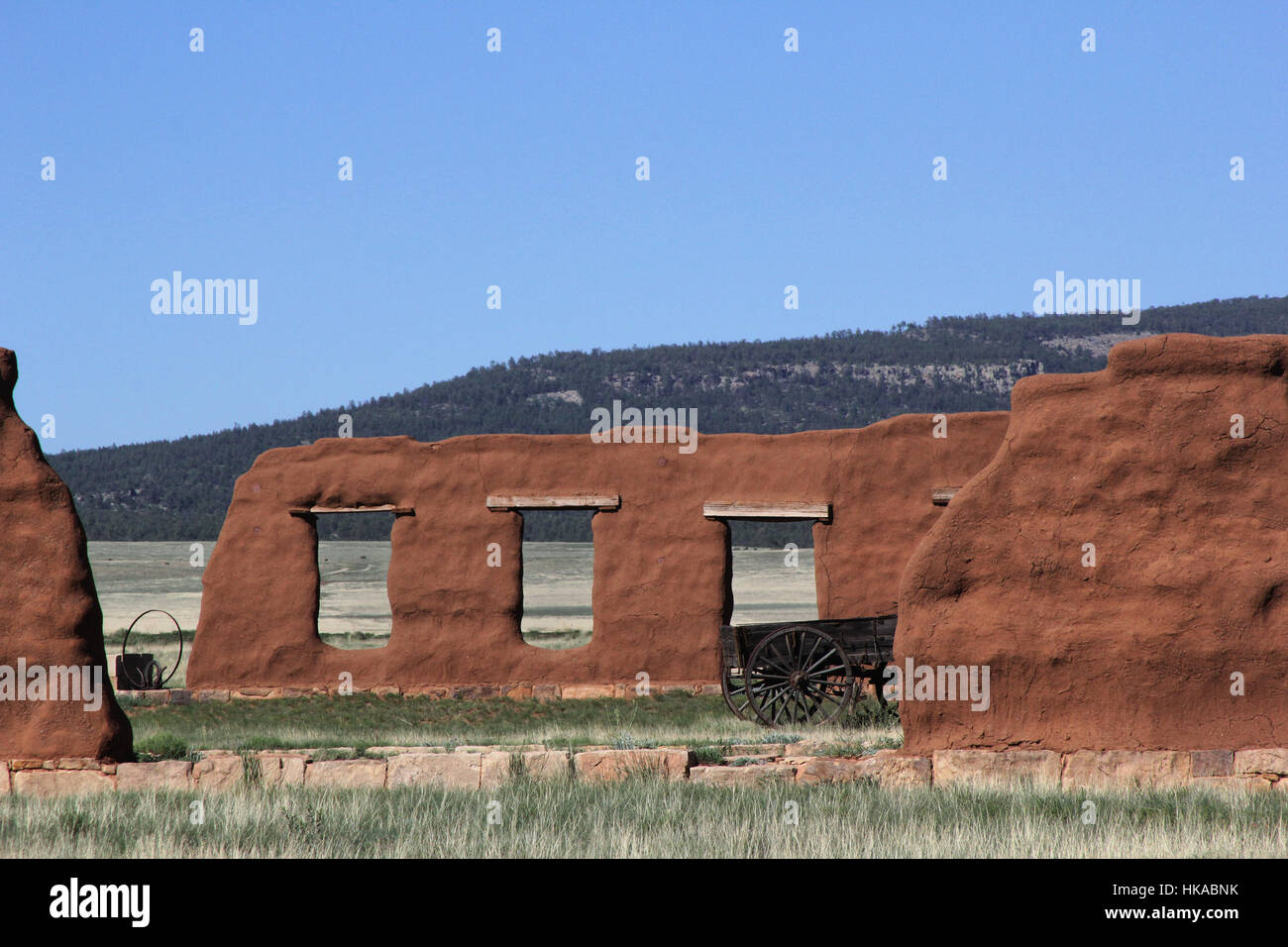 Wagon stands near the remains of the adobe walls of the third Fort Union on the Santa Fe Trail in New Mexico. Stock Photo