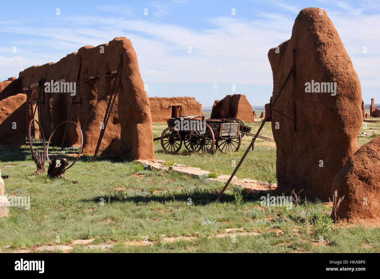 Wagons stand near remaining adobe walls of Fort Union, New Mexico. The military fort stood on the Santa Fe Trail. Stock Photo