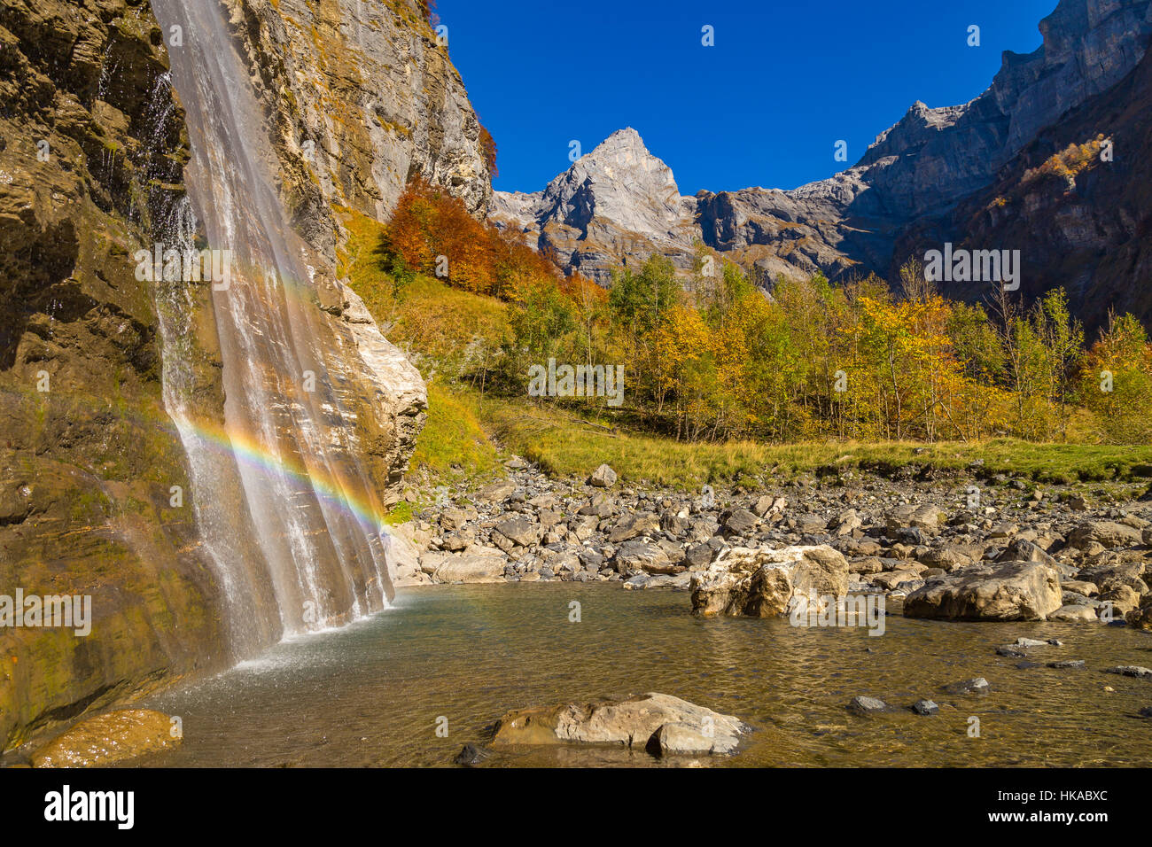 Rainbow in a waterfall in the mountains of the Alps Stock Photo