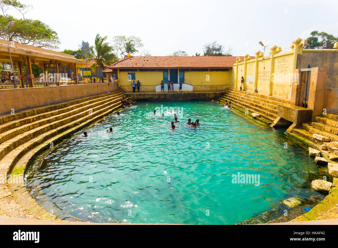 Sri Lankan people swimming in the Keerimalai Hot Springs, a tourist attraction on the northern coast of Jaffna. Horizontal Stock Photo