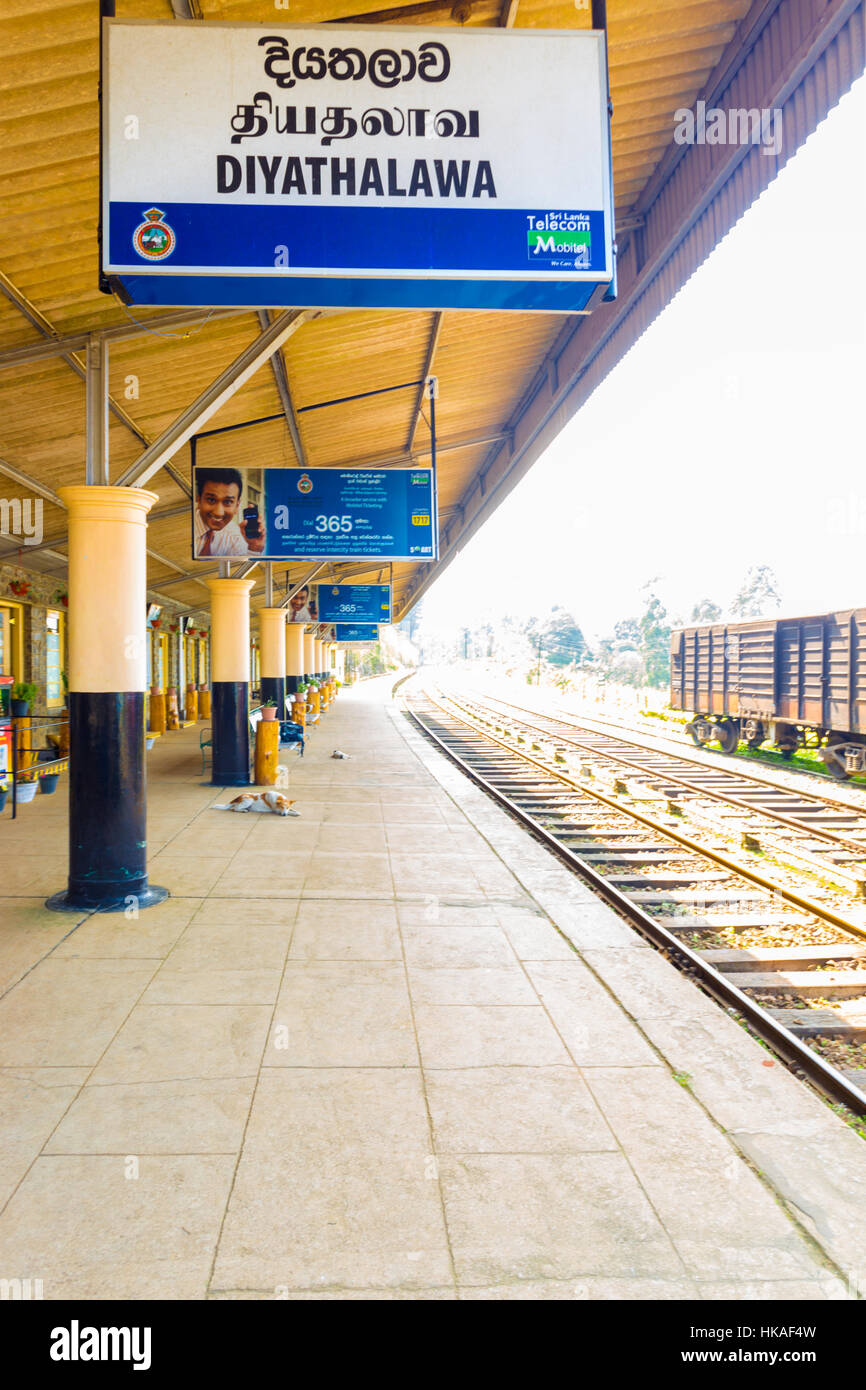 Train tracks and empty platform with sign of railway station at Diyathalawa, a travel destination for local tourists Stock Photo