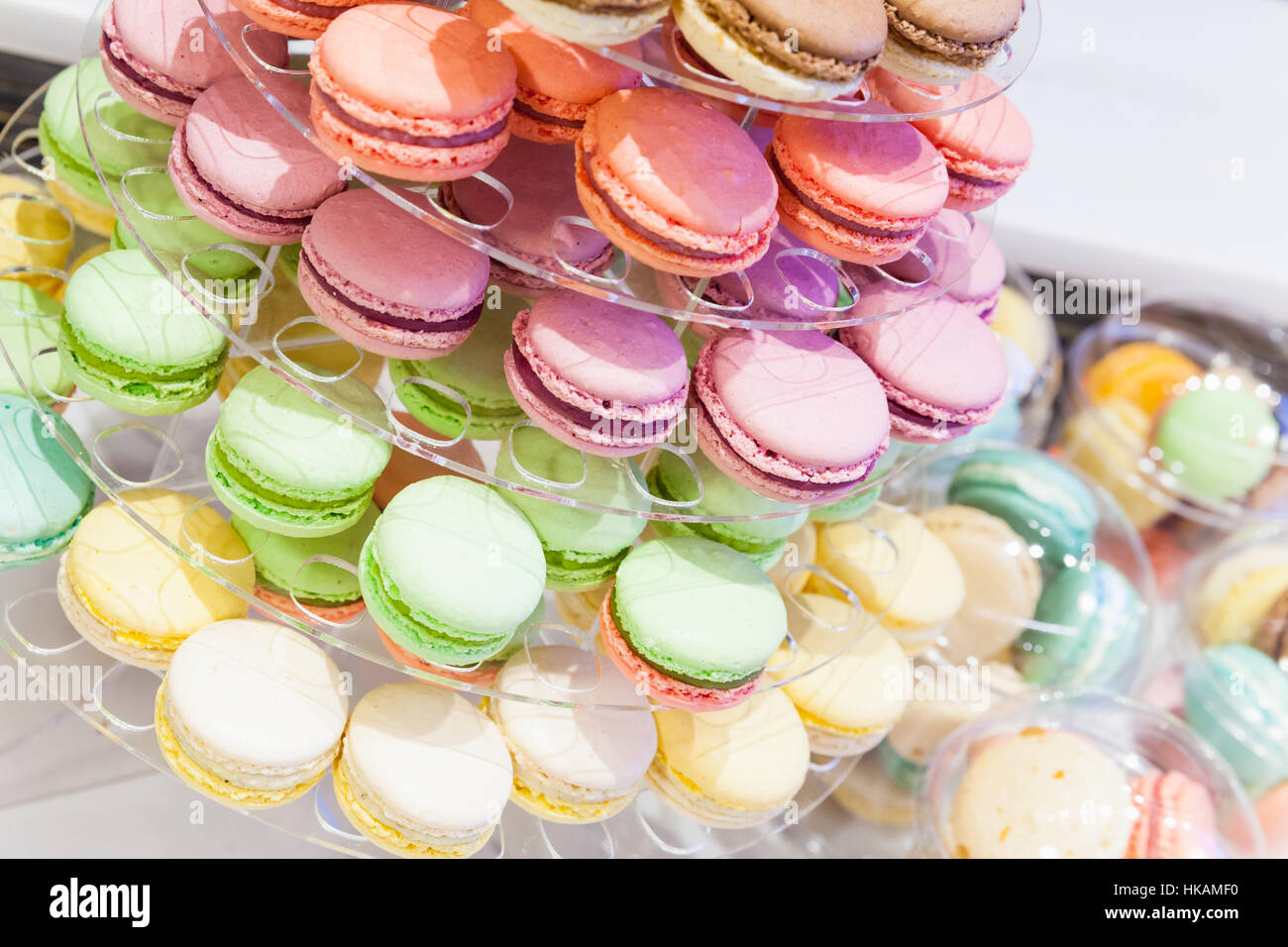 Assortment of colorful traditional French macarons lays on market counter Stock Photo