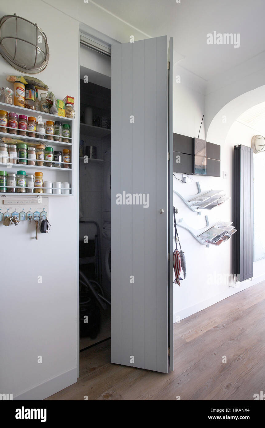 An Open Folding Cupboard Door In A Modern Kitchen In The Uk
