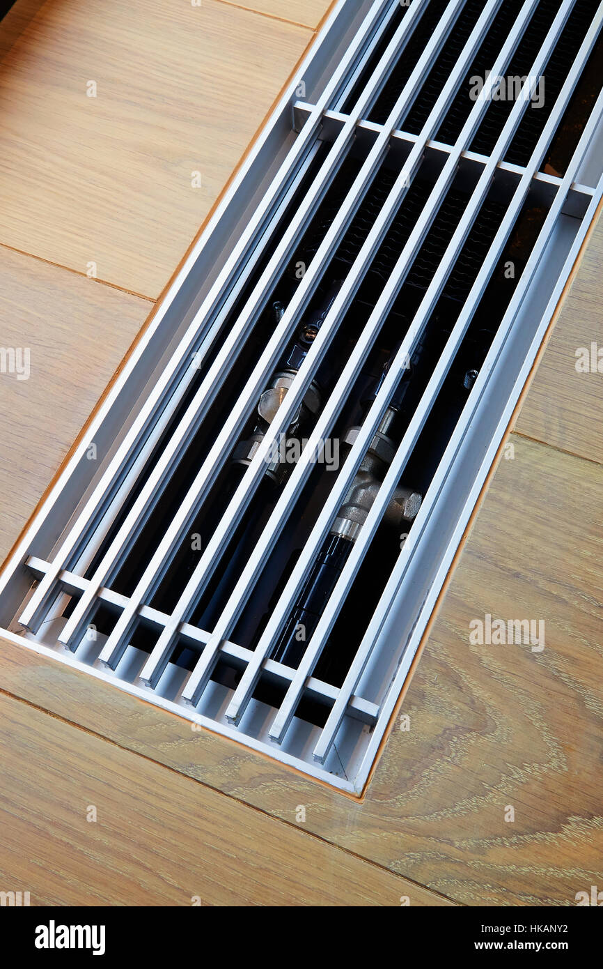 Heating grid with ventilation by the floor in hardwood flooring Stock Photo