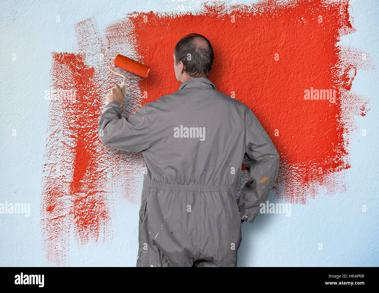 Test painting the blue wall with red color Stock Photo