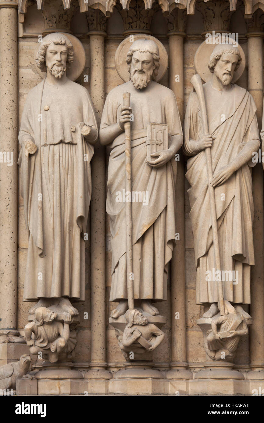 Apostles St Bartholomew, St Simon the Zealot and St James the Less (from left to right). Neo-Gothic statues on the main facade of the Notre-Dame Cathedral (Notre-Dame de Paris) in Paris, France. Damaged Gothic statues on the main facade were restored by French architects Eugene Viollet-le-Duc and Jean-Baptiste Lassus in the 1840s. Stock Photo