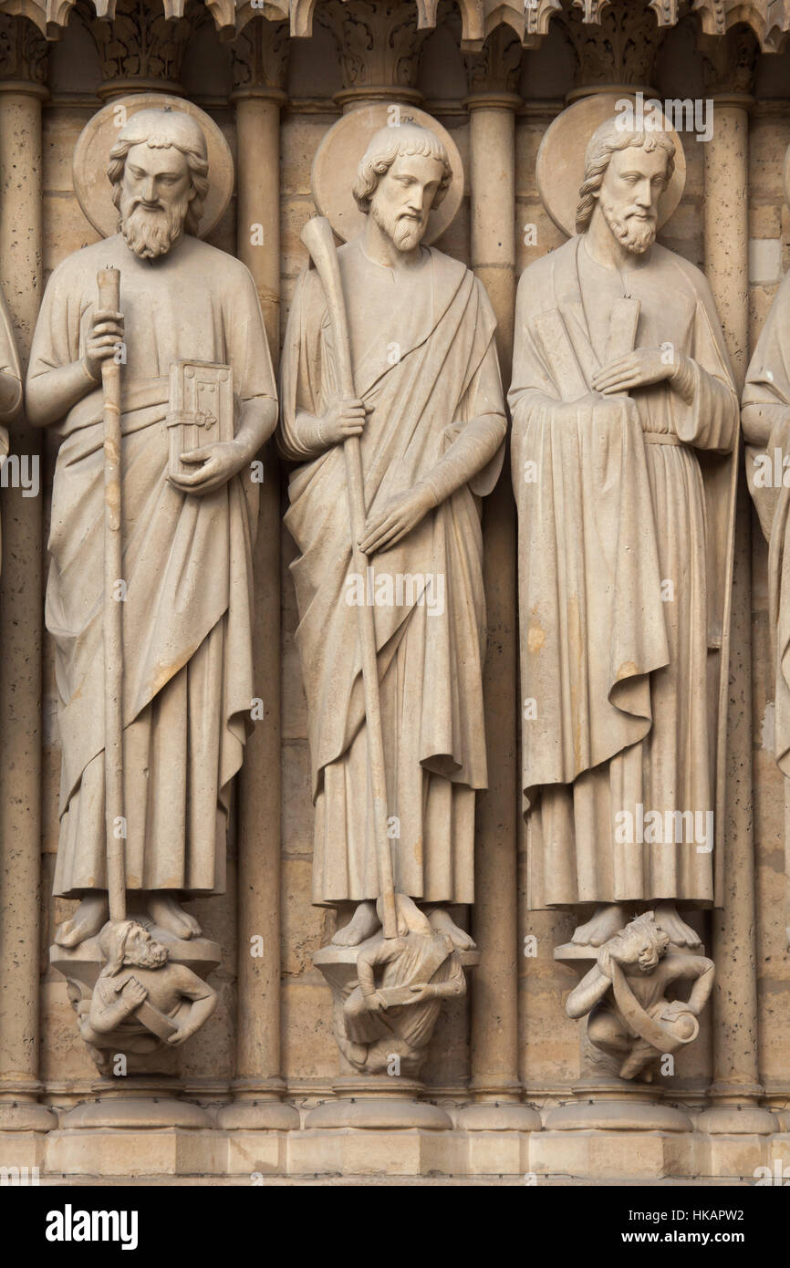 Apostles St Simon the Zealot, St James the Less and St Andrew (from left to right). Neo-Gothic statues on the main facade of the Notre-Dame Cathedral (Notre-Dame de Paris) in Paris, France. Damaged Gothic statues on the main facade were restored by French architects Eugene Viollet-le-Duc and Jean-Baptiste Lassus in the 1840s. Stock Photo