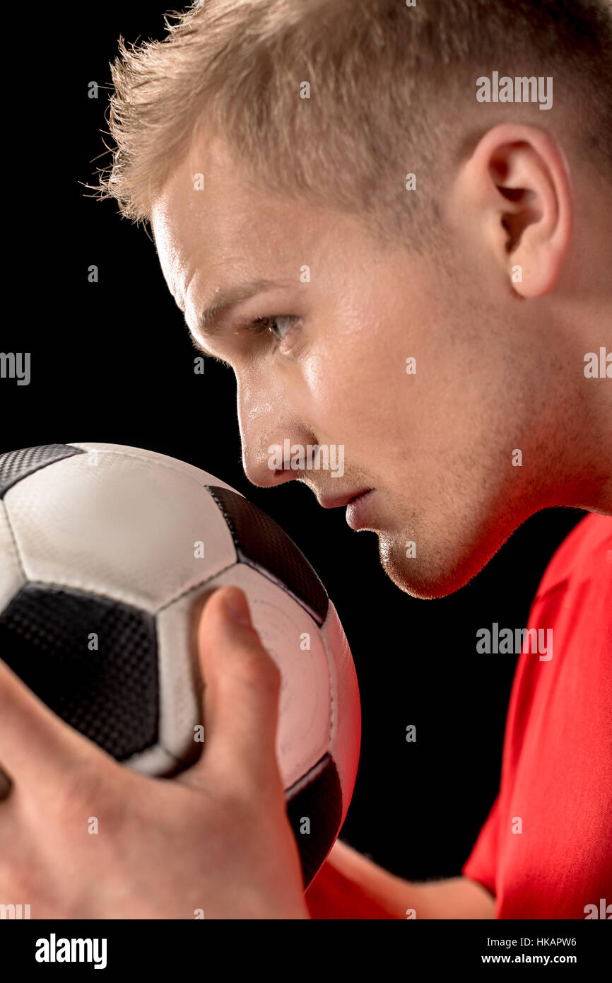 Soccer player holding ball Stock Photo
