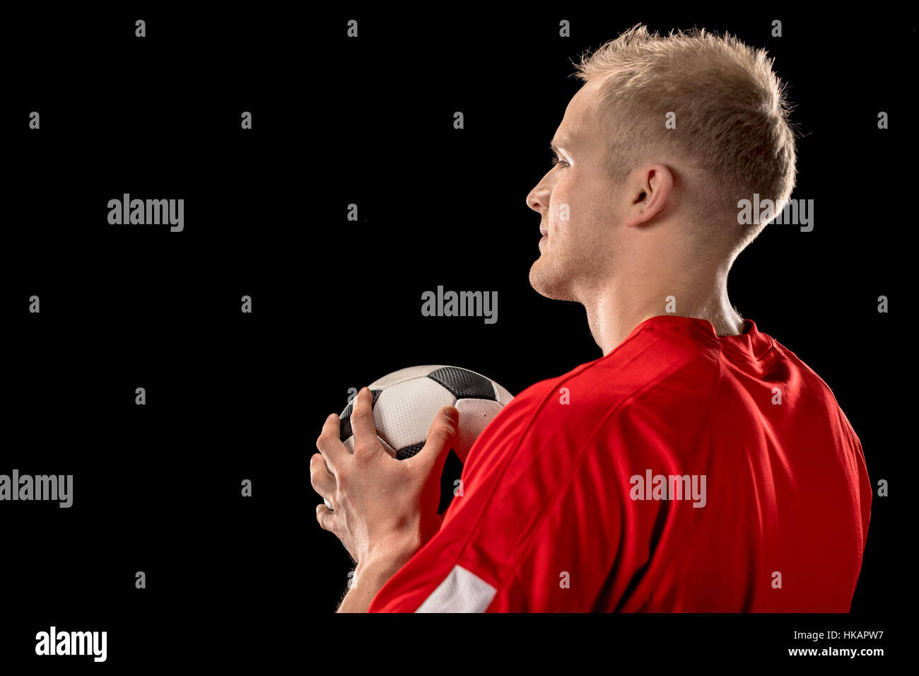 Soccer player holding ball Stock Photo
