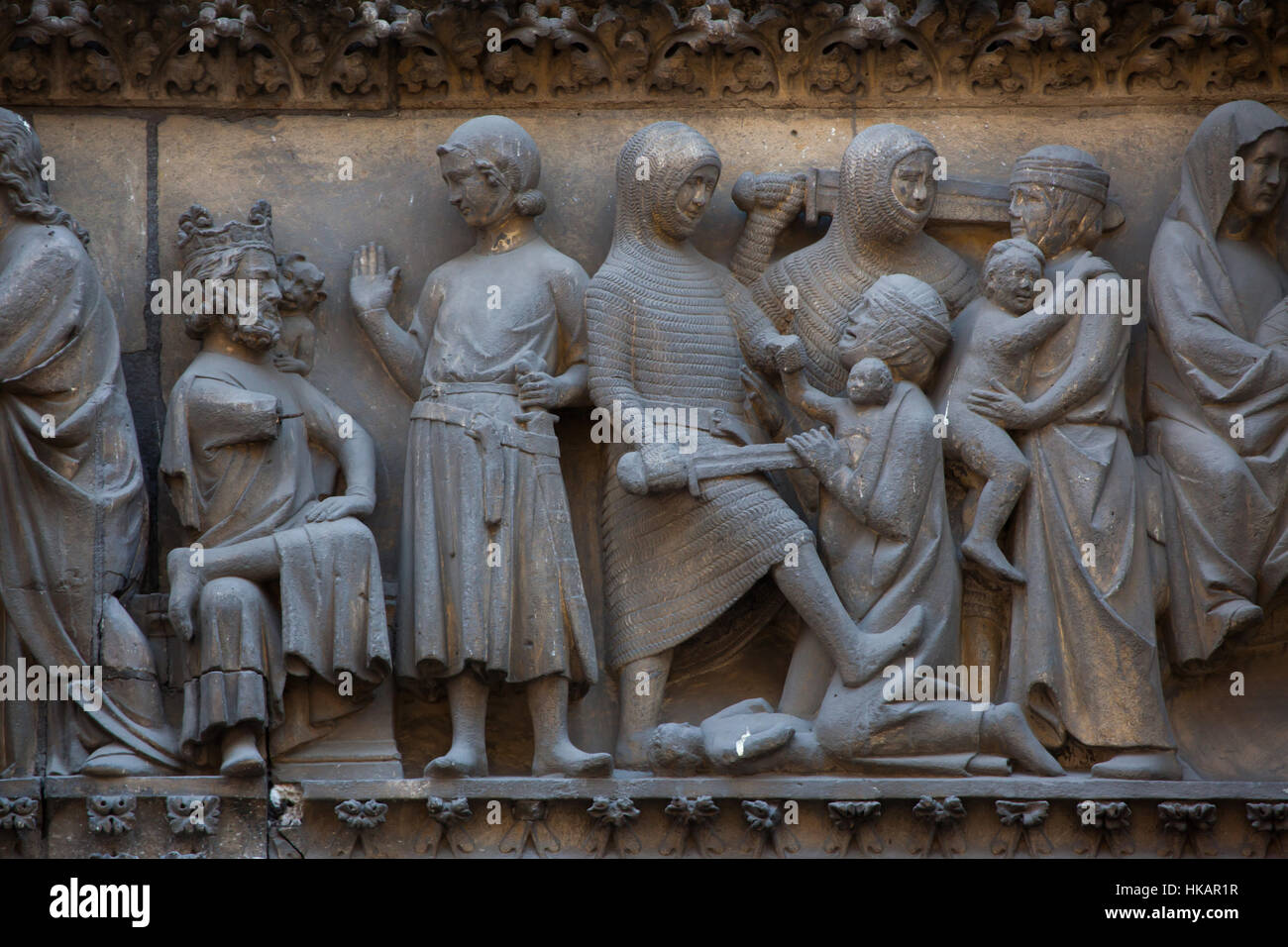 King Herod the Great and the Massacre of the Innocents. Detail of the Gothic tympanum from circa 1250 on the northern facade of the Notre-Dame Cathedral (Notre-Dame de Paris) in Paris, France. Stock Photo