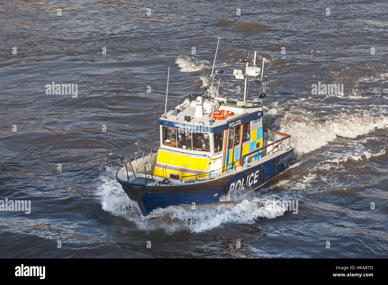 A Thames River Police launch making good speed as it approaches Westminster Bridge Stock Photo
