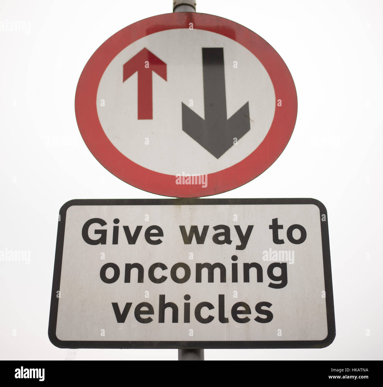 Single lane traffic, give way, UK Urban road sign Stock Photo