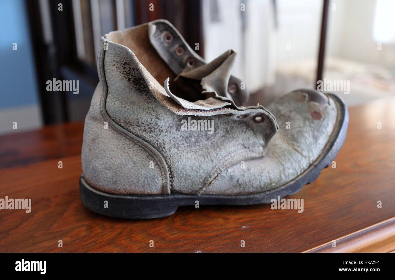 Old miners boot in the museum at the Kolmanskop abandoned diamond mine in Namibia Stock Photo