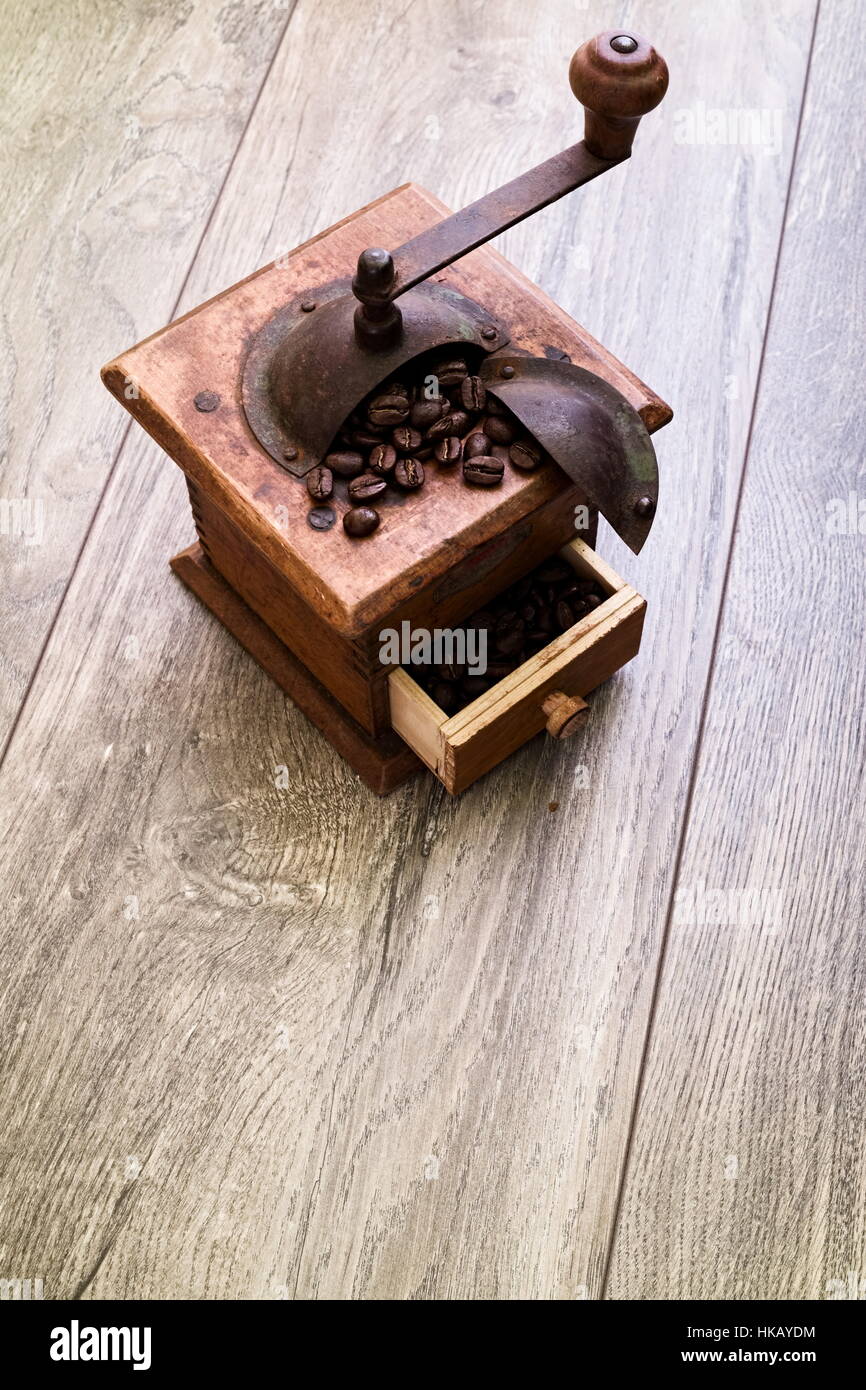 Rustic wooden antique manual coffee grinder with open drawer and handle ...