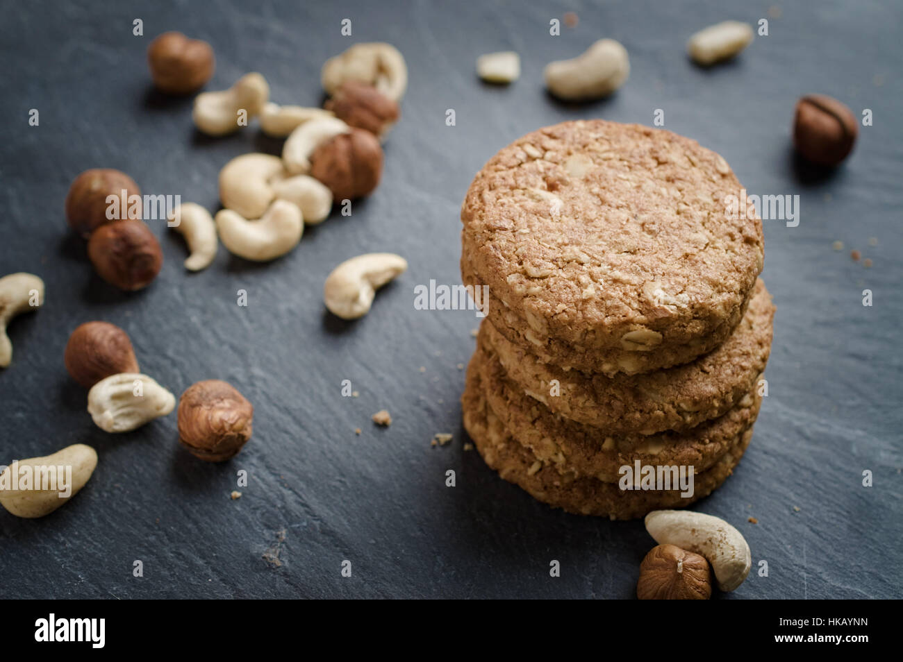 Whole grain cereal shortbread biscuits cookies stacked on black slate