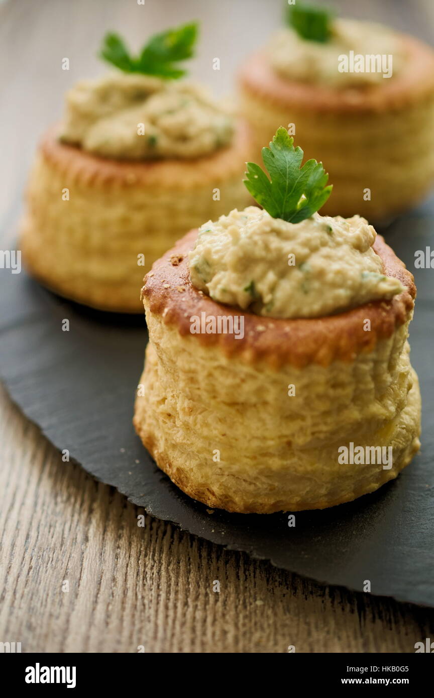 Puff pastry bouchees dough cups filled with tuna spread and garnished