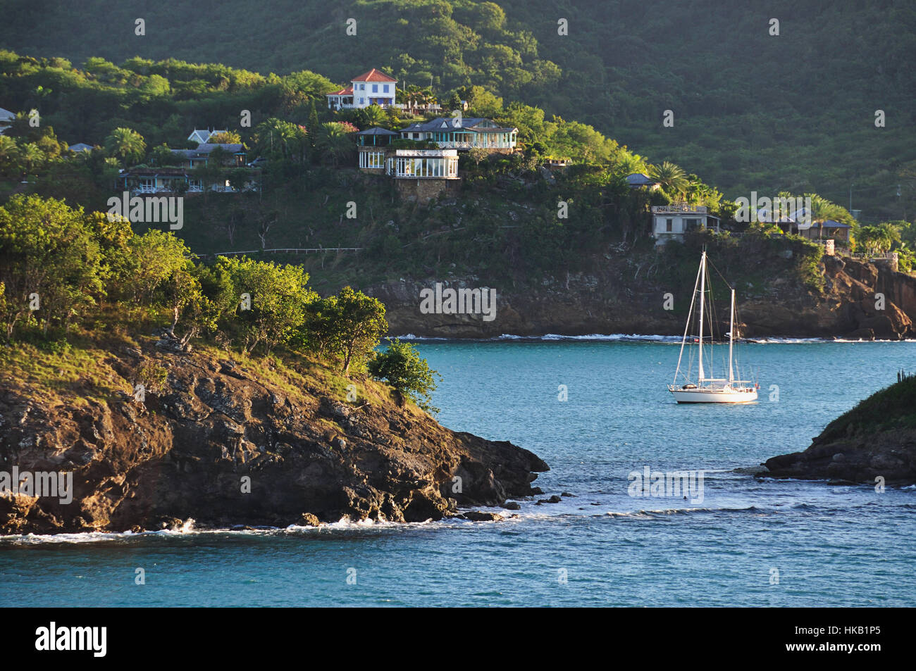 Yacht moving in bay of caribbean sea Stock Photo