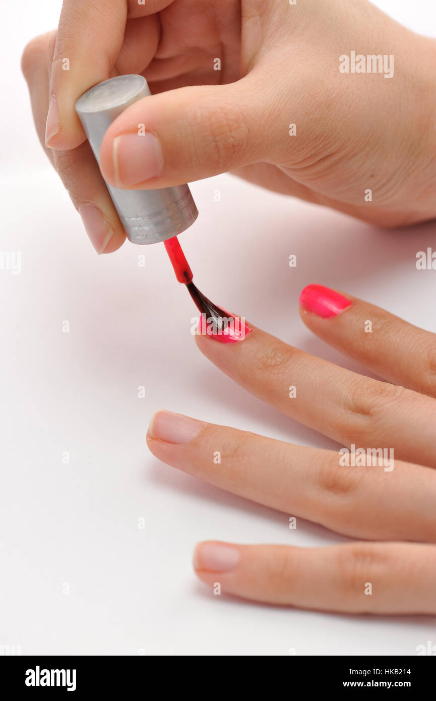 Painting nails with pink color Stock Photo